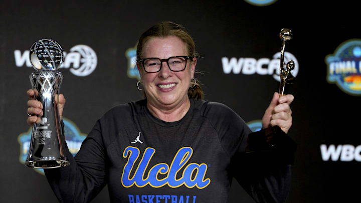 Apr 3, 2025; Tampa, FL, USA; UCLA Bruins coach Cori Close poses with the AP and WBCA Coach of the Year trophies during press conference at Amalie Arena. Mandatory Credit: Kirby Lee-Imagn Images