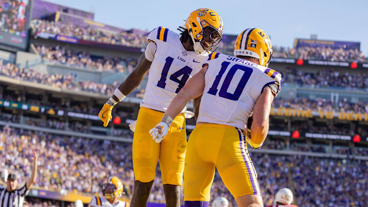  LSU Tigers tight end Trey'Dez Green (14) celebrates a touchdown by tight end Bauer Sharp (10) against the Arkansas Razorbacks during the second half at Tiger Stadium.