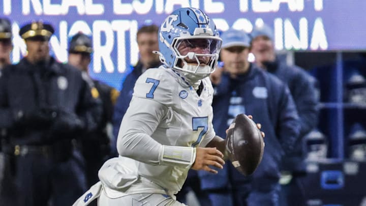Nov 29, 2025; Raleigh, North Carolina, USA;  North Carolina Tar Heels quarterback Gio Lopez (7) runs with the football during the first half of the game against NC State Wolfpack at Carter-Finley Stadium.  Mandatory Credit: Jaylynn Nash-Imagn Images