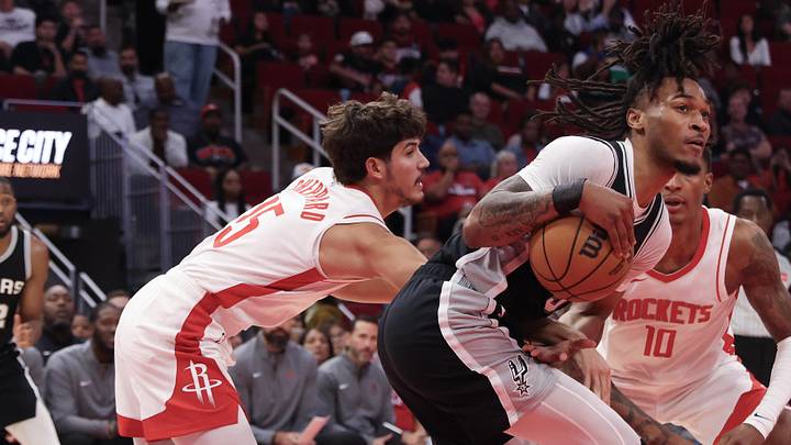 Oct 17, 2024; Houston, Texas, USA; Houston Rockets guard Reed Sheppard (15) reaches in against San Antonio Spurs guard Stephon Castle (5) in the second quarter at Toyota Center. Mandatory Credit: Thomas Shea-Imagn Images