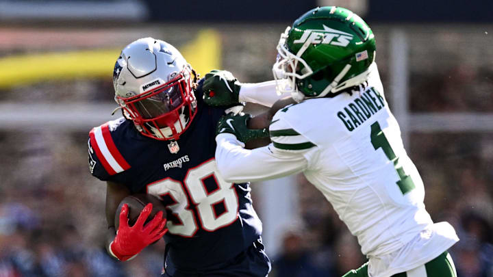 Oct 27, 2024; Foxborough, Massachusetts, USA; New England Patriots running back Rhamondre Stevenson (38) rushes against New York Jets cornerback Sauce Gardner (1) during the first half at Gillette Stadium. Mandatory Credit: Brian Fluharty-Imagn Images