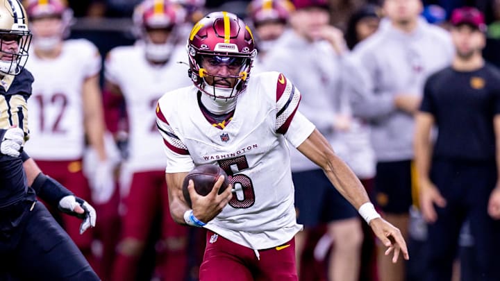 Dec 15, 2024; New Orleans, Louisiana, USA;  Washington Commanders quarterback Jayden Daniels (5) scrambles against the New Orleans Saints during the second half at Caesars Superdome. Mandatory Credit: Stephen Lew-Imagn Images