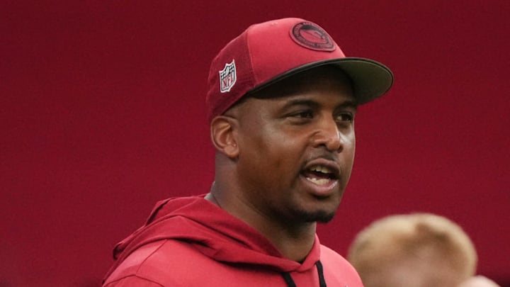 Arizona Cardinals quarterbacks coach Israel Woolfork talks to Clayton Tune (15) during training camp at State Farm Stadium in Glendale on July 25, 2024.