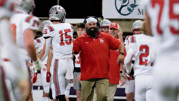 North Scott’s Kye Smith (15) celebrates with a coach after scoring against North Polk Thursday, Nov. 14, 2024 at the UNI-Dome in Cedar Falls, Iowa.