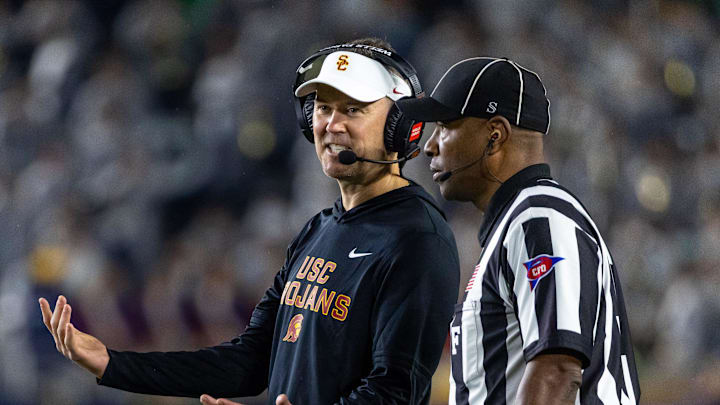 Oct 18, 2025; South Bend, Indiana, USA; Southern California Trojans head coach Lincoln Riley talks to an official during the first half against the Notre Dame Fighting Irish at Notre Dame Stadium. Mandatory Credit: Michael Caterina-Imagn Images