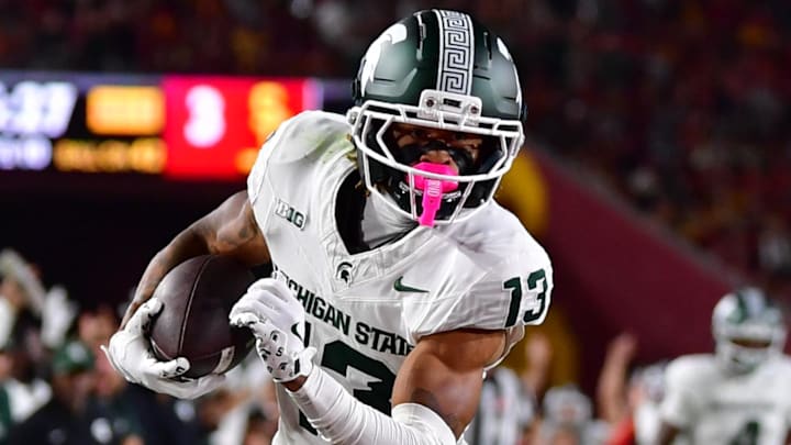 Sep 20, 2025; Los Angeles, California, USA; Michigan State Spartans wide receiver Chrishon McCray (13) scores a touchdown against the against the Southern California Trojans during the first half at the Los Angeles Memorial Coliseum. Mandatory Credit: Gary A. Vasquez-Imagn Images