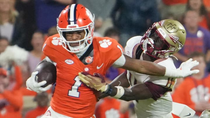 Nov 8, 2025; Clemson, South Carolina, USA; Florida State Seminoles defensive back Ja'Bril Rawls (11) tackles Clemson Tigers wide receiver T.J. Moore (1) during the second quarter at Memorial Stadium. Mandatory Credit: Ken Ruinard - GREENVILLE NEWS-USA TODAY Network via Imagn Images
