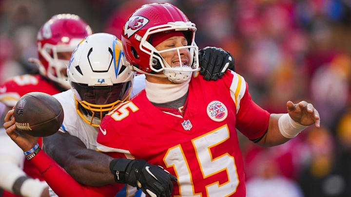 Dec 14, 2025; Kansas City, Missouri, USA; Los Angeles Chargers linebacker Odafe Oweh (98) sacks Kansas City Chiefs quarterback Patrick Mahomes (15) during the second half at GEHA Field at Arrowhead Stadium. Mandatory Credit: Jay Biggerstaff-Imagn Images