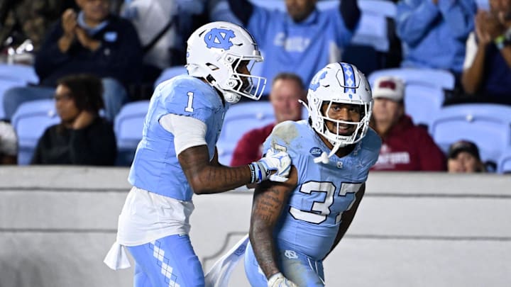 Nov 8, 2025; Chapel Hill, North Carolina, USA; North Carolina Tar Heels running back Davion Gause (37) celebrates with wide receiver Jordan Shipp (1) after scoring a touchdown in the third quarter at Kenan Stadium. Mandatory Credit: Bob Donnan-Imagn Images