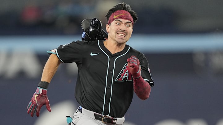 Arizona Diamondbacks right fielder Carroll loses his helmet as he runs to third base on a triple against the Toronto Blue Jays at Rogers Centre. 