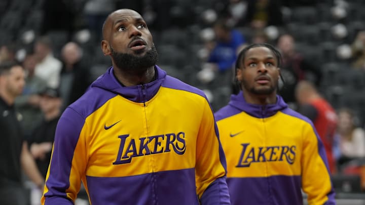 Los Angeles Lakers forward LeBron James and son Bronny James warm up before a game. Los Angeles Lakers forward LeBron James and son Bronny James warm up before a game.