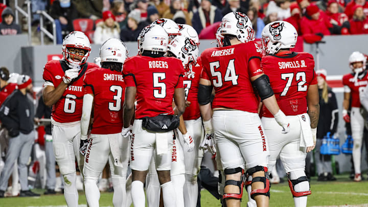 Nov 29, 2025; Raleigh, North Carolina, USA;  NC State Wolfpack huddles during the first half of the game against North Carolina Tar Heels at Carter-Finley Stadium.  Mandatory Credit: Jaylynn Nash-Imagn Images