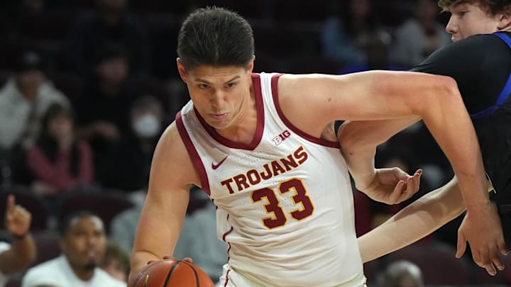 Nov 13, 2024; Los Angeles, California, USA; Southern California Trojans forward Josh Cohen (33) dribbles against Texas-Arlington Mavericks forward Jaxon Ellingsworth (22) at Galen Center. Mandatory Credit: Kirby Lee-Imagn Images