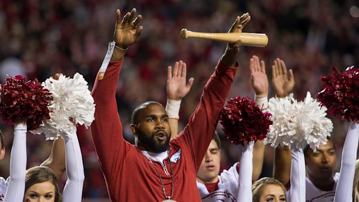 Arkansas Razorbacks former running back Darren McFadden (center) is honored between quarters and helps the spirit squad lead the crowd in a cheer during the game against the LSU Tigers at Razorback Stadium. 