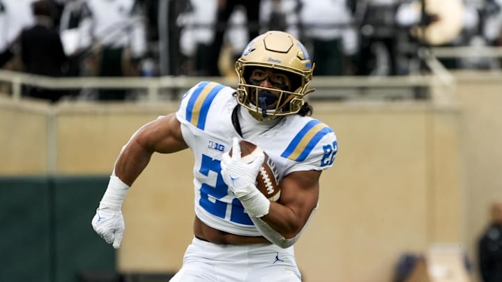 Oct 11, 2025; East Lansing, Michigan, USA; UCLA running back Anthony Frias II (22) runs for a first down against Michigan State in the fourth quarter at Spartan Stadium. Mandatory Credit: Brendan Mullin-Imagn Images Oct 11, 2025; East Lansing, Michigan, USA; UCLA running back Anthony Frias II (22) runs for a first down against Michigan State in the fourth quarter at Spartan Stadium. Mandatory Credit: Brendan Mullin-Imagn Images