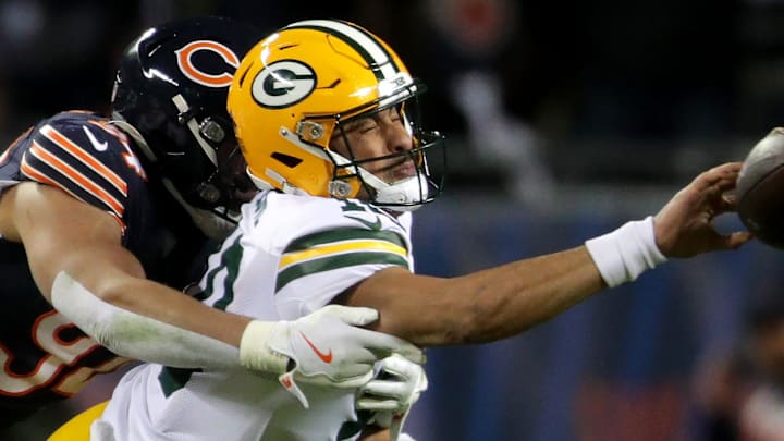 Green Bay Packers quarterback Jordan Love (10) is pressured by Chicago Bears defensive end Austin Booker.