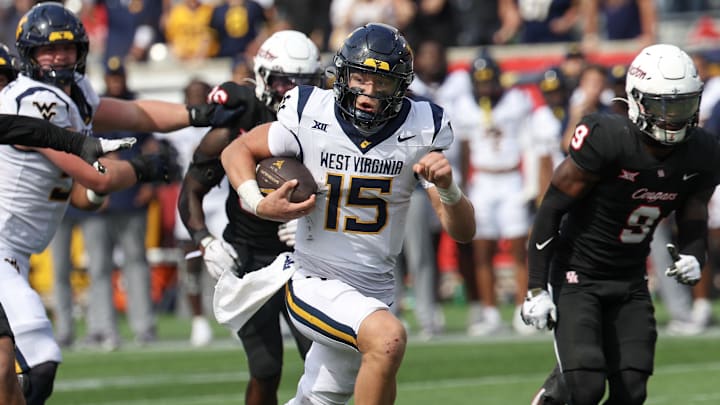 Nov 1, 2025; Houston, Texas, USA; West Virginia Mountaineers quarterback Scotty Fox Jr. (15) rushes for a touchdown against the Houston Cougars in the second half at TDECU Stadium. 