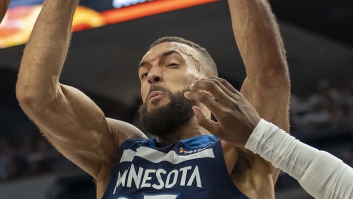 May 14, 2025; Minneapolis, Minnesota, USA; Minnesota Timberwolves center Rudy Gobert (27) dunks the ball over Golden State Warriors forward Kevon Looney (5) in the first half during game five of the second round for the 2025 NBA Playoffs at Target Center. Mandatory Credit: Jesse Johnson-Imagn Images