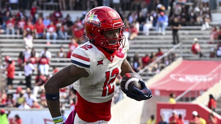 Oct 18, 2025; Houston, Texas, USA; Arizona Wildcats wide receiver Tre Spivey (12) runs the ball in for a touchdown during the fourth quarter against the Houston Cougars at TDECU Stadium. Mandatory Credit: Maria Lysaker-Imagn Images 