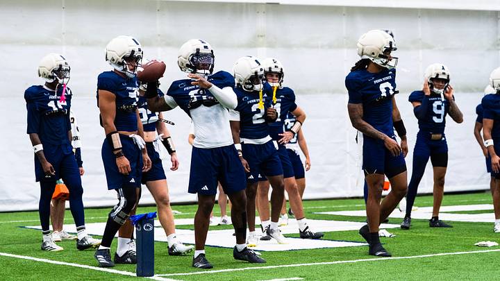 Penn State football players warm up at the beginning of a practice session inside Holuba Hall on Monday, August 10, 2026, in State College.