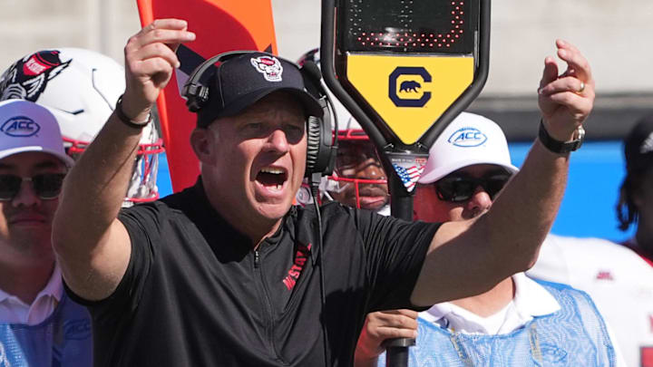 Oct 19, 2024; Berkeley, California, USA; North Carolina State Wolfpack head coach Dave Doeren (center) yells during the second quarter against the California Golden Bears at California Memorial Stadium. Mandatory Credit: Darren Yamashita-Imagn Images