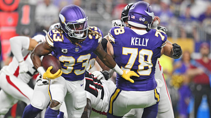 Sep 14, 2025; Minneapolis, Minnesota, USA; Minnesota Vikings running back Aaron Jones Sr. (33) runs the ball during the first half against the Atlanta Falcons at U.S. Bank Stadium.