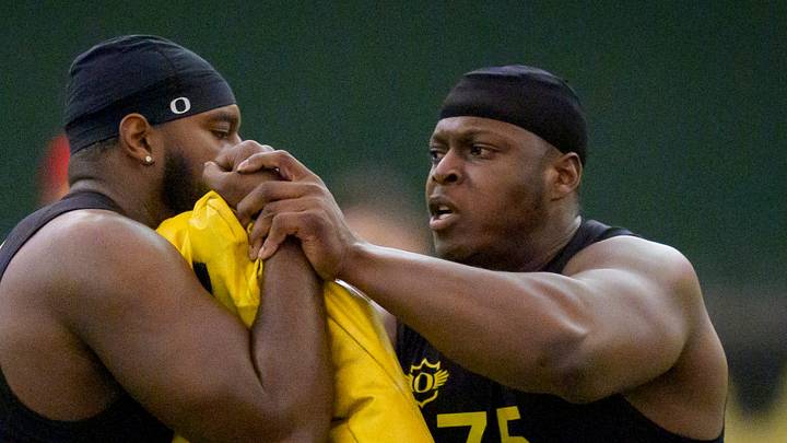 Oregon offensive lineman Emmanuel Pregnon, right, hits offensive lineman Matthew Bedford during Oregon Pro Day on March 17, 2026, at the Moshofsky Center in Eugene, Oregon.