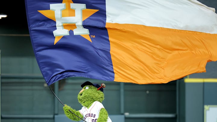 May 22, 2025; Houston, Texas, USA; Houston Astros mascot Orbit waves a flag in center field after the final out  against the Seattle Mariners during the ninth inning at Daikin Park. Mandatory Credit: Erik Williams-Imagn Images