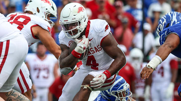 Arkansas Razorbacks running back Mike Washington Jr. (4) runs with the ball against the Memphis Tigers during the second half at Simmons Bank Liberty Stadium.