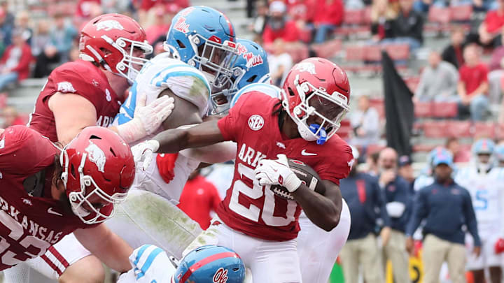 Arkansas Razorbacks running back Rodney Hill (20) scores a touchdown in the third quarter as Ole Miss Rebels linebacker Khari Coleman (23) defends at Donald W. Reynolds Razorback Stadium. Arkansas Razorbacks running back Rodney Hill (20) scores a touchdown in the third quarter as Ole Miss Rebels linebacker Khari Coleman (23) defends at Donald W. Reynolds Razorback Stadium.