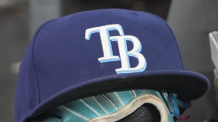 Sep 26, 2025; Toronto, Ontario, CAN; The hat and glove of Tampa Bay Rays third baseman Junior Caminero (13) in the dugout during the game against the Toronto Blue Jays at Rogers Centre. 