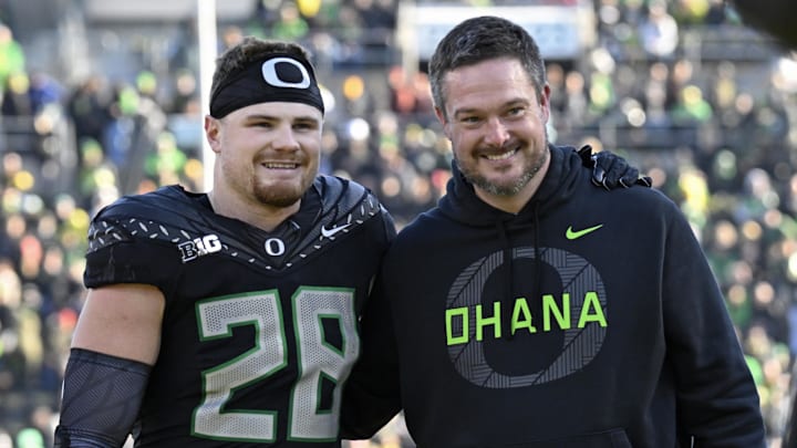 Nov 22, 2025; Eugene, Oregon, USA; Oregon Ducks linebacker Bryce Boettcher (28) poses for a photo head coach Dan Lanning before the game against the Southern California Trojans at Autzen Stadium. Mandatory Credit: Troy Wayrynen-Imagn Images Nov 22, 2025; Eugene, Oregon, USA; Oregon Ducks linebacker Bryce Boettcher (28) poses for a photo head coach Dan Lanning before the game against the Southern California Trojans at Autzen Stadium. Mandatory Credit: Troy Wayrynen-Imagn Images