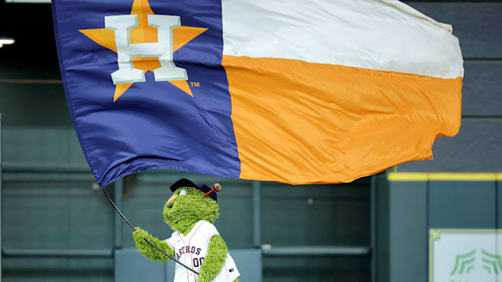 May 22, 2025; Houston, Texas, USA; Houston Astros mascot Orbit waves a flag in center field after the final out  against the Seattle Mariners during the ninth inning at Daikin Park. Mandatory Credit: Erik Williams-Imagn Images