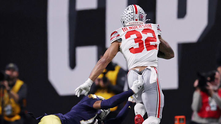 Jan 20, 2025; Atlanta, GA, USA; Notre Dame Fighting Irish cornerback Leonard Moore (15) attempts to tackle Ohio State Buckeyes running back TreVeyon Henderson (32) during the second half the CFP National Championship college football game at Mercedes-Benz Stadium. 
