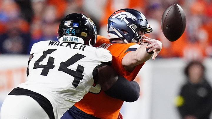 Dec 21, 2025; Denver, Colorado, USA; Jacksonville Jaguars defensive end Travon Walker (44) hits Denver Broncos quarterback Bo Nix (10) during the second half at Empower Field at Mile High. Mandatory Credit: Ron Chenoy-Imagn Images
