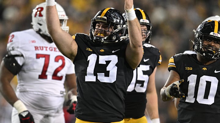 Nov 11, 2023; Iowa City, Iowa, USA; Iowa Hawkeyes defensive end Joe Evans (13) and linebacker Nick Jackson (10) react during the fourth quarter against the Rutgers Scarlet Knights at Kinnick Stadium. Mandatory Credit: Jeffrey Becker-Imagn Images