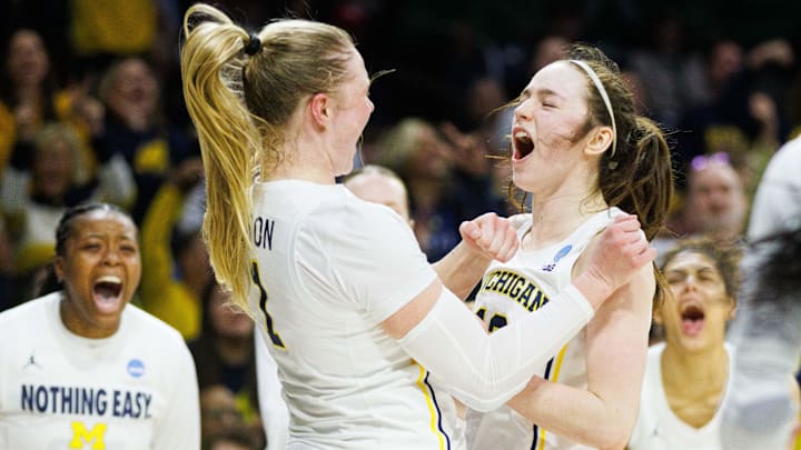 Michigan guard Olivia Olson (1) and guard Syla Swords, right, celebrate Olson scoring a basket and drawing a foul during the first round of the NCAA Women's Basketball Tournament between Michigan and Iowa State at Purcell Pavilion on Friday, March 21, 2025, in South Bend.