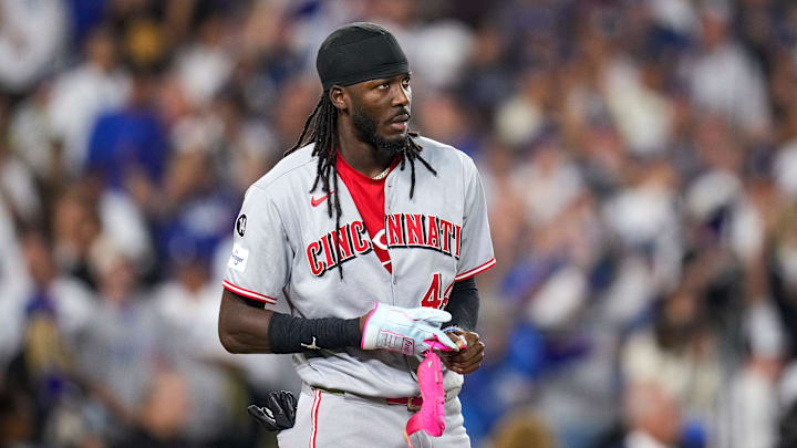 Cincinnati Reds shortstop Elly De La Cruz (44) takes off his batting gloves after striking out with the bases loaded to end the top of the sixth inning of the MLB National League Wild Card Game 2 between the Los Angeles Dodgers and the Cincinnati Reds at Dodger Stadium in Los Angeles on Wednesday, Oct. 1, 2025. The Reds were eliminated from the postseason with an 8-4 loss to the reining World Series Champions La Dodgers.