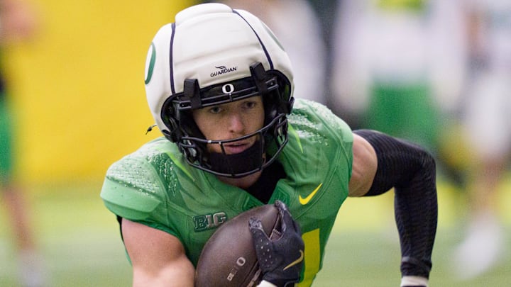Oregon defensive back Dillon Thieneman carries the ball as the Oregon Ducks practice on Jan. 5, 2025, at the Moshofsky Center in Eugene, Oregon, ahead of the Peach Bowl. Oregon defensive back Dillon Thieneman carries the ball as the Oregon Ducks practice on Jan. 5, 2025, at the Moshofsky Center in Eugene, Oregon, ahead of the Peach Bowl.