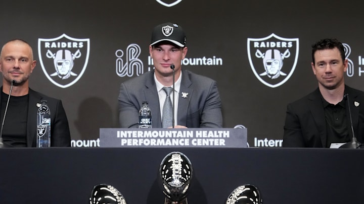 Apr 24, 2026; Henderson, NV, USA; Las Vegas Raiders quarterback Fernando Mendoza (center) speaks at introductory press conference at Intermountain Health Performance Center flanked by general manager John Spytek (left) and head coach Klint Kubiak after being selected as the No. 1 pick in the 2026 NFL Draft. Mandatory Credit: Kirby Lee-Imagn Images