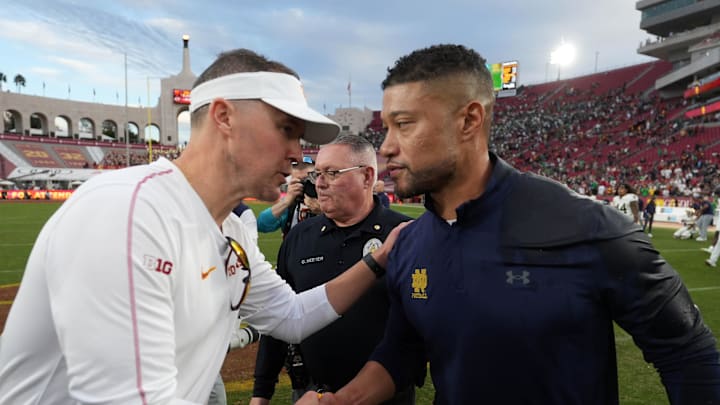 Nov 30, 2024; Los Angeles, California, USA; Southern California Trojans head coach Lincoln Riley and Notre Dame Fighting Irish head coach Marcus Freeman shake hands after the game at United Airlines Field at Los Angeles Memorial Coliseum. Mandatory Credit: Kirby Lee-Imagn Images