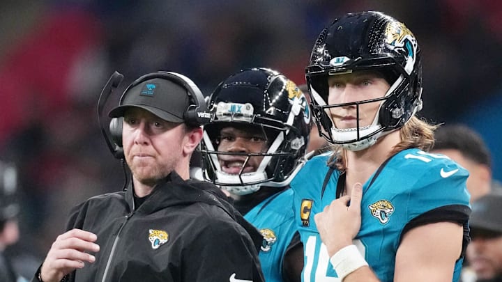 Oct 19, 2025; London, United Kingdom; Jacksonville Jaguars head coach Liam Coen talks with quarterback Trevor Lawrence (16) on the sidelines during the second half of an NFL International Series game at Wembley Stadium. Mandatory Credit: Kirby Lee-Imagn Images