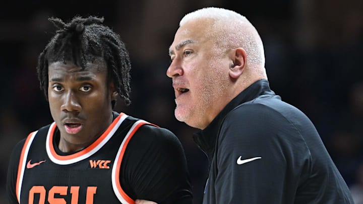 Jan 28, 2025; Spokane, Washington, USA; Oregon State Beavers head coach Wayne Tinkle, right talks with Oregon State Beavers forward Maxim Logue (77) during a game against the Gonzaga Bulldogs in the second half at McCarthey Athletic Center. Mandatory Credit: James Snook-Imagn Images