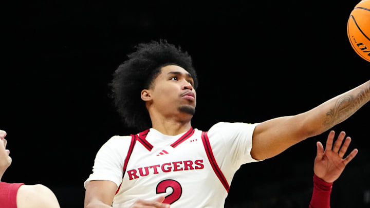 Nov 27, 2024; Las Vegas, Nevada, USA; Rutgers Scarlet Knights guard Dylan Harper (2) shoots between Alabama Crimson Tide forward Grant Nelson (4) and Alabama Crimson Tide forward Jarin Stevenson (15) during the first half at MGM Grand Garden Arena. Mandatory Credit: Stephen R. Sylvanie-Imagn Images
