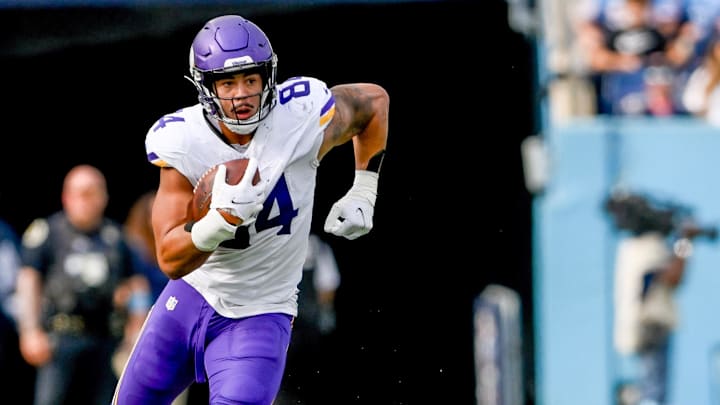 Nov 17, 2024; Nashville, Tennessee, USA;  Minnesota Vikings tight end Josh Oliver (84) runs the ball after a made catch against the Tennessee Titans during the first half at Nissan Stadium.