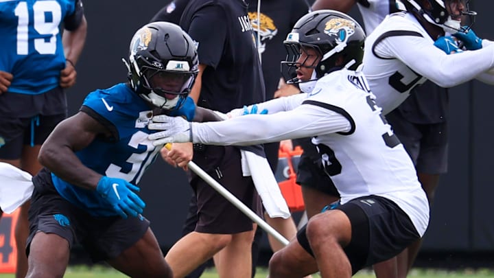 Jacksonville Jaguars running back J'Mari Taylor (30) and safety Devin Neal (36) drill during rookie minicamp at the Miller Electric Center, Saturday, May 9, 2026 in Jacksonville, Fla. Today was the second of a three day camp concluding Sunday.