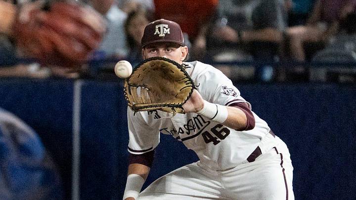 Auburn Tigers' Taylor Belza (25) dives safely back into first base before Texas A&M Aggies' Blake Binderup (46) gets the ball as Auburn Tigers take on Texas A&M Aggies during the SEC baseball tournament at Hoover Metropolitan Stadium in Hoover, Ala., on Friday, May 22, 2026. Auburn Tigers' Taylor Belza (25) dives safely back into first base before Texas A&M Aggies' Blake Binderup (46) gets the ball as Auburn Tigers take on Texas A&M Aggies during the SEC baseball tournament at Hoover Metropolitan Stadium in Hoover, Ala., on Friday, May 22, 2026.