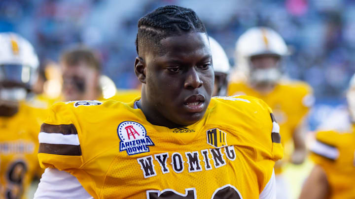 Dec 30, 2022; Tucson, AZ, USA; Wyoming Cowboys guard Emmanuel Pregnon (76) against the Ohio Bobcats during the 2022 Barstool Sports Arizona Bowl at Arizona Stadium. Mandatory Credit: Mark J. Rebilas-Imagn Images
