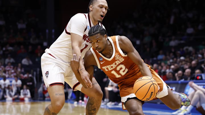 Texas Longhorns guard Tramon Mark drives to the basket defended by NC State Wolfpack forward Darrion Williams in the second half during a first four game of the men's 2026 NCAA Tournament at University of Dayton Arena. 