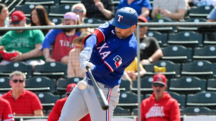 Texas Rangers second baseman Tyler Wade swings his bat.